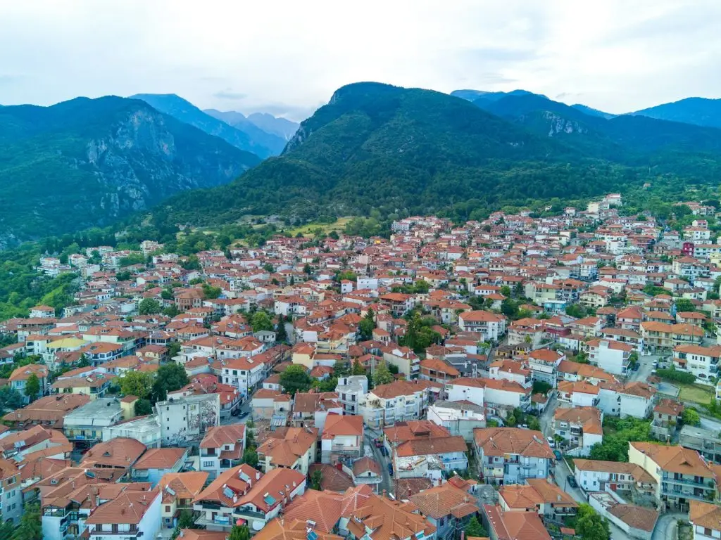 Greek town of Litochoro with small houses against the backdrop of the Mount Olympus and a cloudy sky