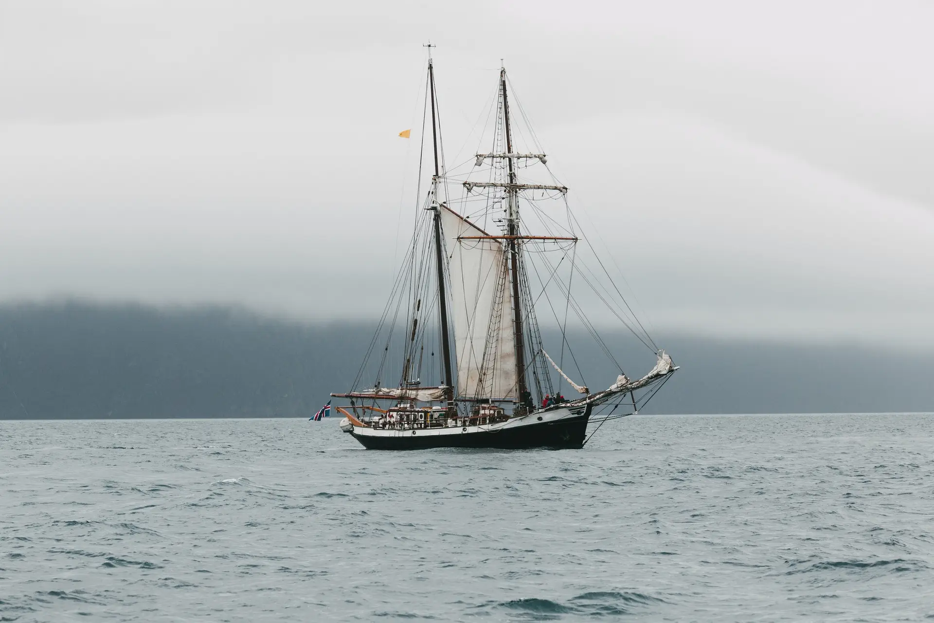 HUSAVIK, ICELAND - 20 JULY, 2016: yacht floating on waves near icelandic coast, husavik, iceland