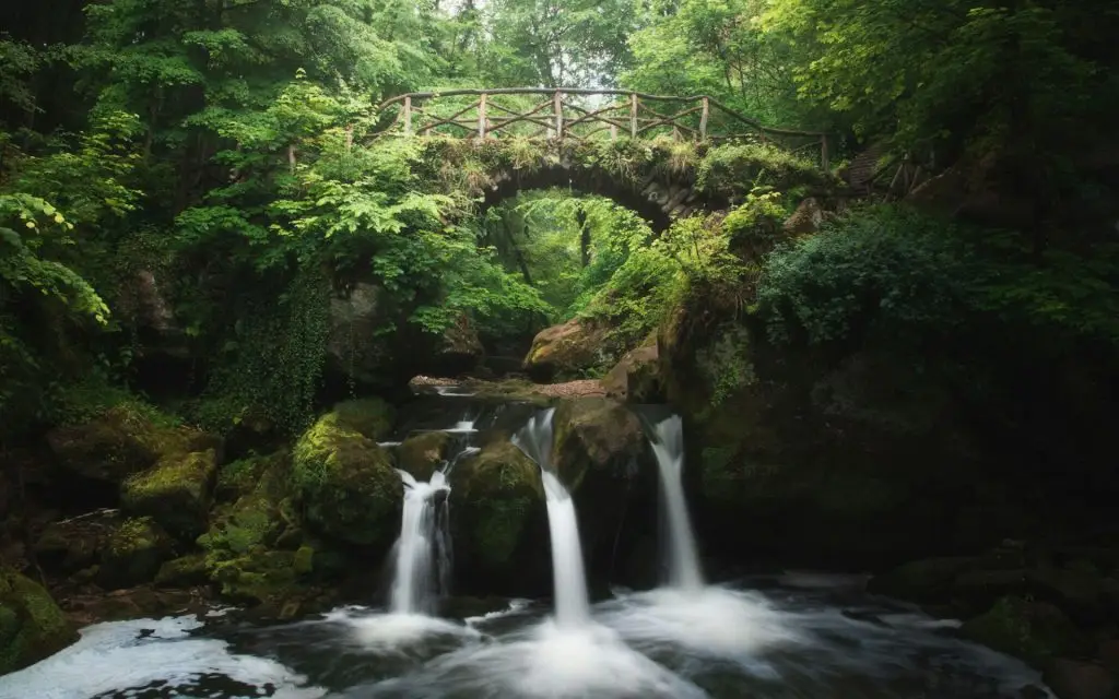 Landscape of the Schiessenstumpfel waterfall in Luxembourg with mossy rocks