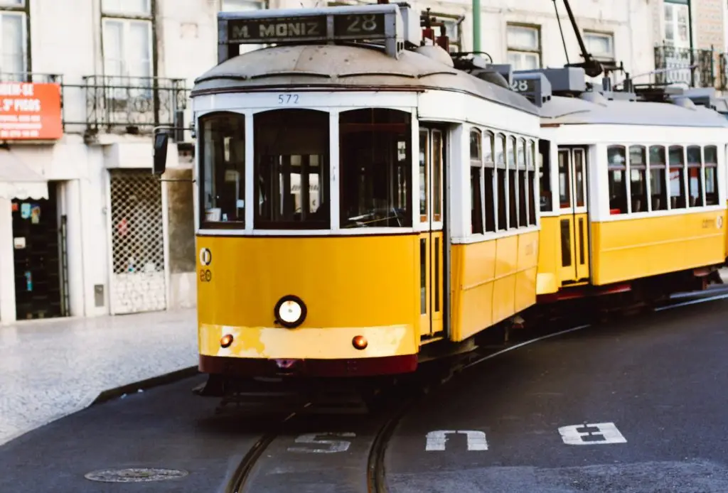 Lisbon street with yellow tramcar, Portugal.