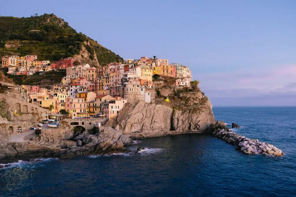 Rocky hills and colorful historic buildings of Manarola, Italy.