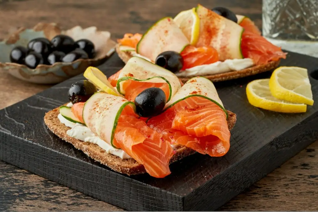 Smorrebrod - traditional Danish sandwiches. Black rye bread with salmon, cream cheese