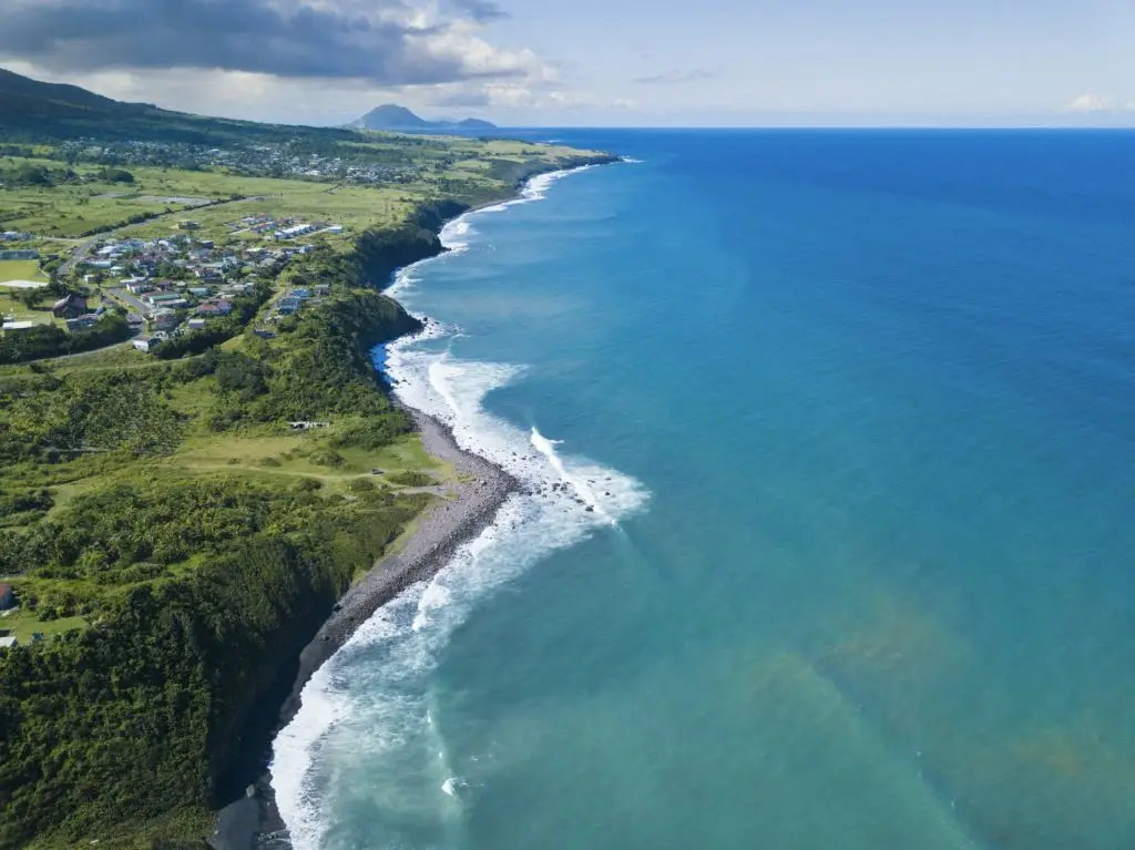 Aerial view of Black Rocks Beach on St Kitts with the island of