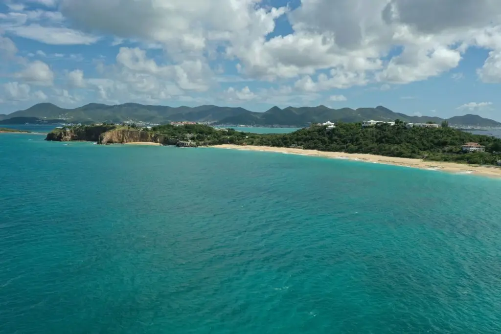 Aerial view of the sea waves touching the sandy beach of St. Martin, Baie Longue