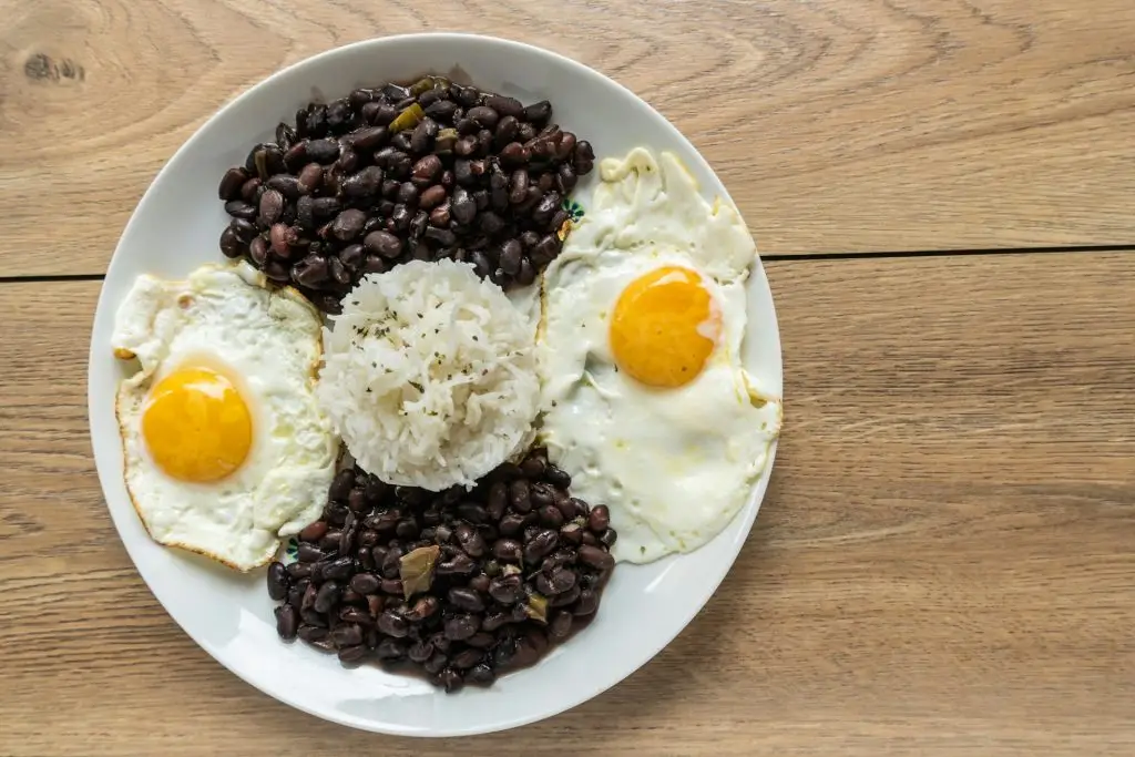 Dish of traditional Cuban cuisine with black beans, rice, and eggs