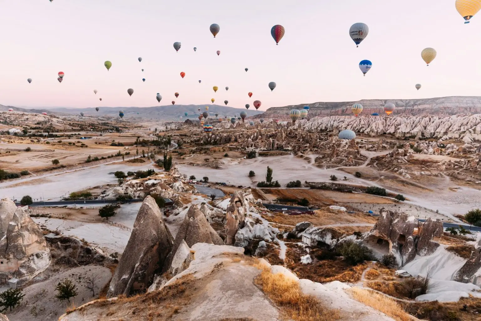 Early morning in Cappadocia, the flight of balloons. A large number of flying balloons in Cappadocia