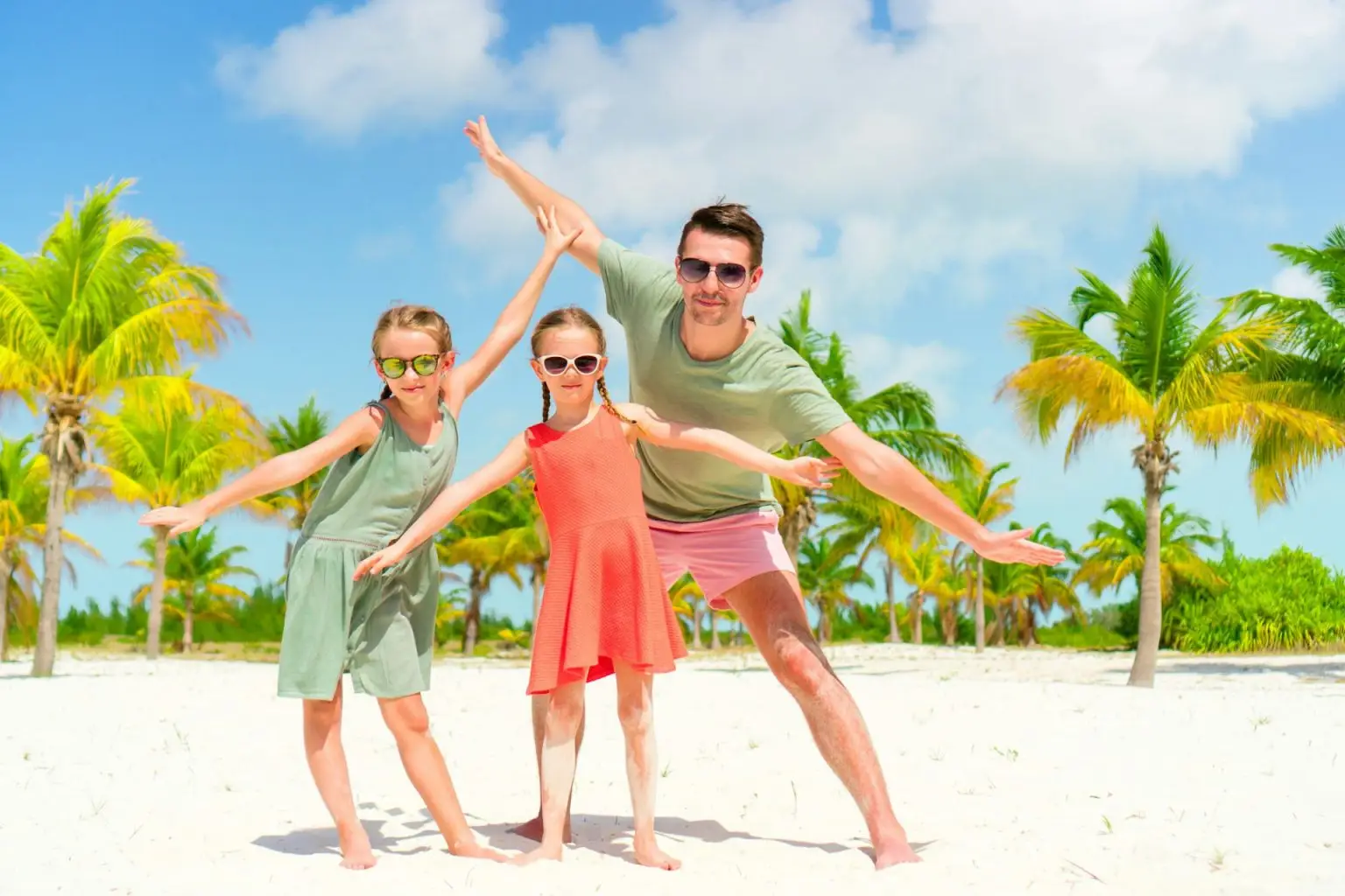 Family walking on white tropical beach on caribbean island