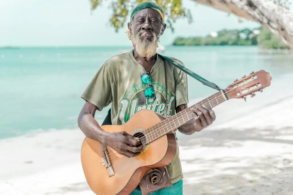 Jamaican man playing guitar