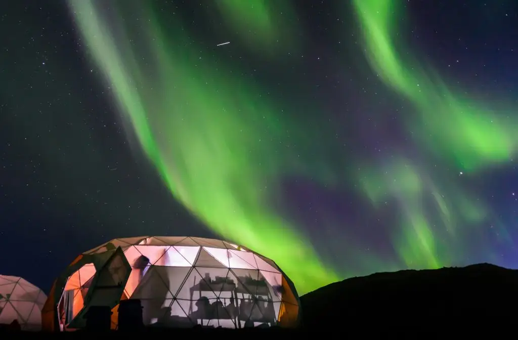 Lit up dome tent, Aurora Borealis in background, Narsaq, Vestgronland, Greenland