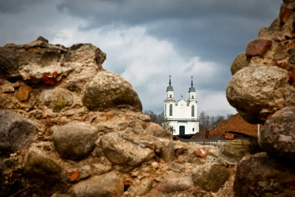 Modern temple behind the ruins of ancient medieval castle of times of the Grand Duchy of Lithuania