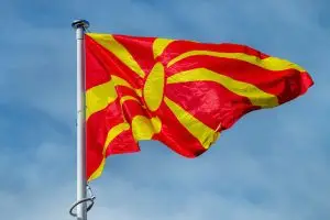 The national flag of Serbia waving in the blue sky