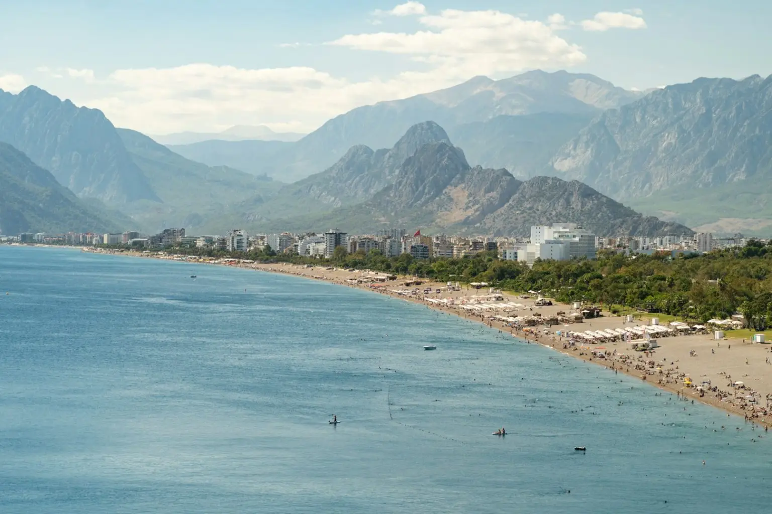 Turkey beach with picturesque sea and tourists spending their summer holidays on azure coast Antalya