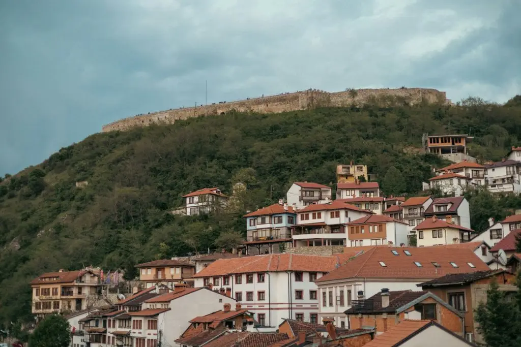 View of Prishtina, Kosovo, featuring a series of houses and buildings on a hill
