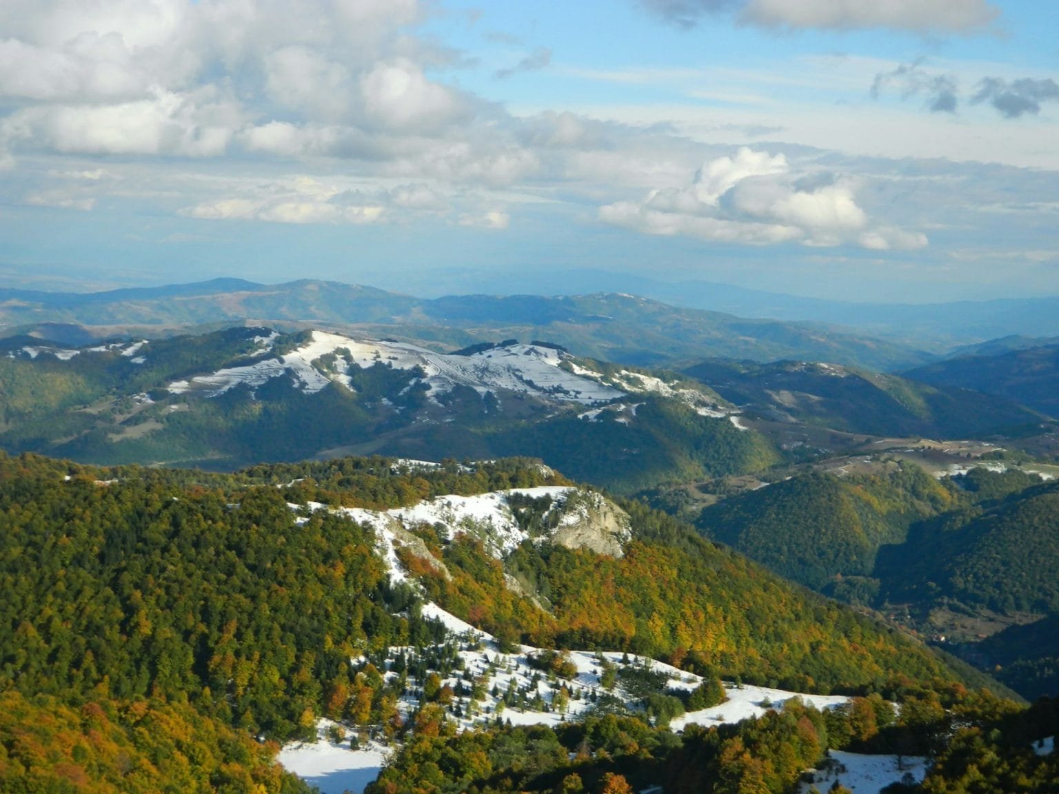 Landscape of the Kopaonik mountain range under the sunlight and a blue cloudy sky in Serbia