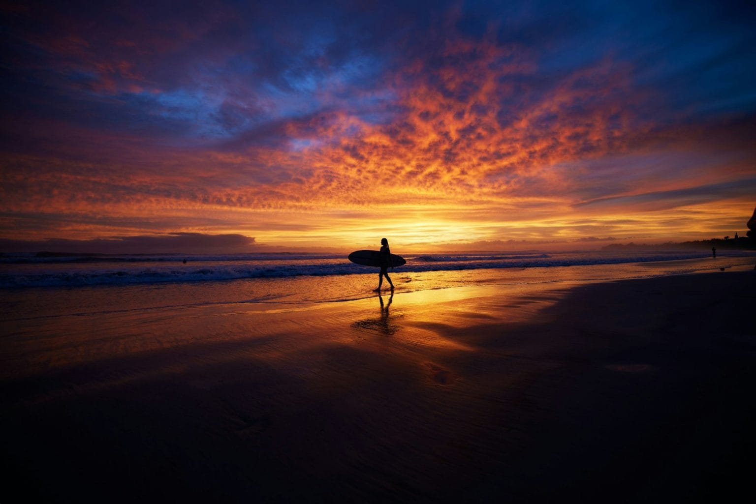 Silhouette of surfer in the background of vibrant sunset scenery, Nosara peninsula, Costa Rica