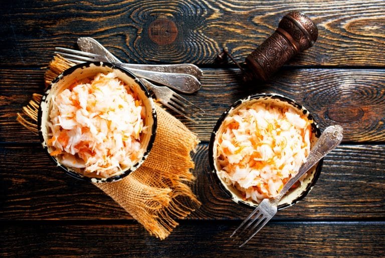 fresh pickled cabbage (german sauerkraut) with ingredients in bowl