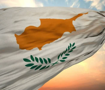Closeup view of the flag of the Cyprus on a background of sunset