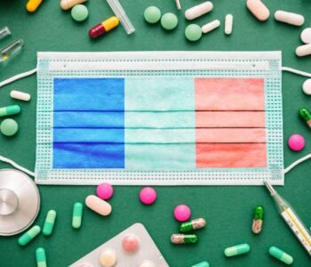 Covid19 virus in France, protective surgical french flag mask and medicine background.