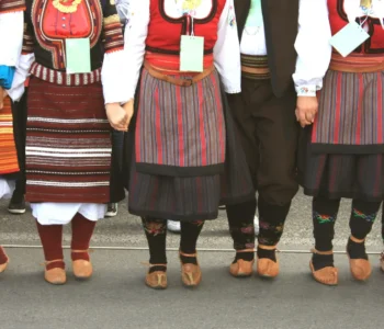 folklore group from Serbia dressed in traditional clothing is preforming Serbian national dances.