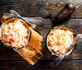 fresh pickled cabbage (german sauerkraut) with ingredients in bowl