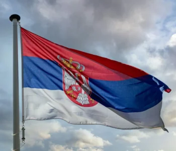 Serbia flag waving against cloudy sky